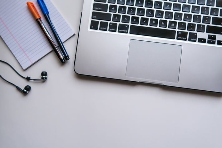Scrivania con pc auricolari e cancelleria
